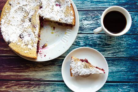 Sliced homemade pie on wooden background, top viewの写真素材