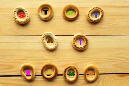 Sweet home bakery with the message stay at home. Wooden background. Stay home conceptの写真素材