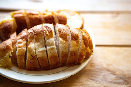 Sliced white bread on wooden background, top viewの写真素材