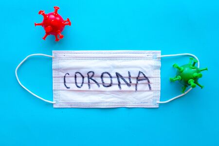 Mask with word Corona on blue background. Coronavirus conceptの写真素材