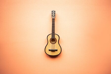 Toy acoustic guitar on pastel pink backgroundの写真素材