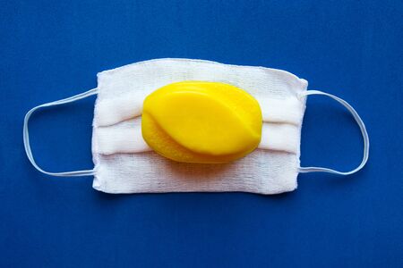 Soap and medical mask on blue background. Coronavirus conceptの写真素材