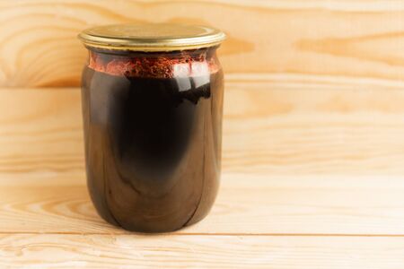 jar of homemade jam on wooden backgroundの写真素材