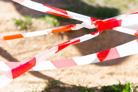 Red and white stripe barrier tape. Fencing red and white tape, warning tape.の写真素材