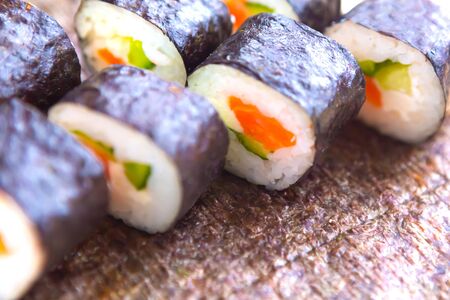  Set of sushi rolls on sushi seaweed background, closeup, top viewの写真素材