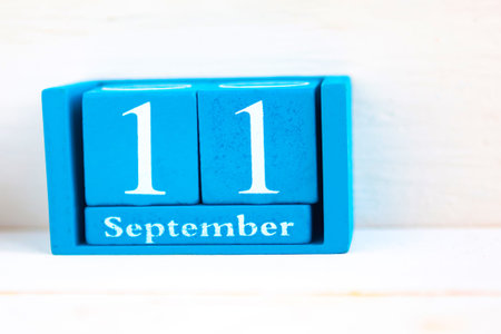 September 11, wooden background. Handmade wooden cube calendar with date month and day