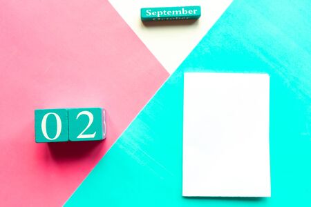 September 2. Wooden handmade calendar and white mockup blank on geometric white, pink and blue backgroundの写真素材