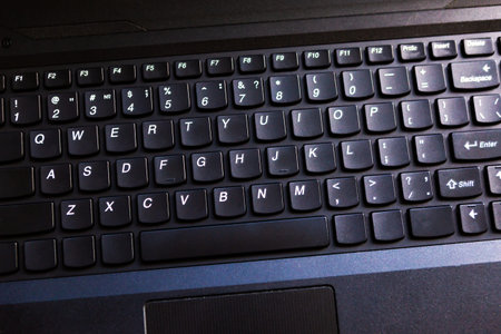 Black keyboard of modern laptop, top view