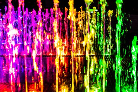 Bright and colorful fountain at night streetの写真素材