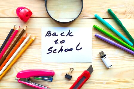School supplies and card with message Back to School on wooden table. Back to school conceptの写真素材
