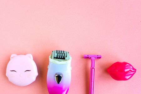 Set for epilation on pastel pink background. Top view, minimal concept, copy space for the textの写真素材