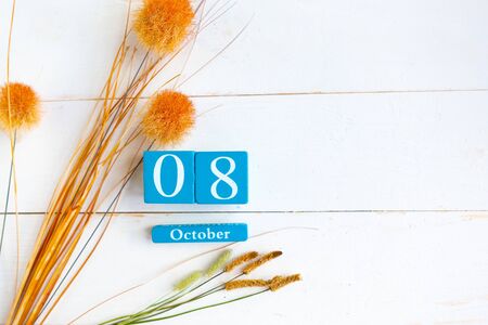 October the 8th. Blue cube calendar with month and date on wooden background. Copy space for the textの写真素材