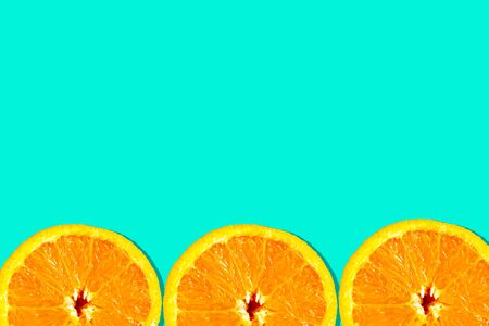 Sliced oranges pattern on green background, minimal concept copy space for the text bannerの写真素材