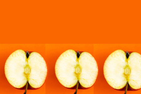 Sliced apple pattern on orange background, copy space for the text, banner