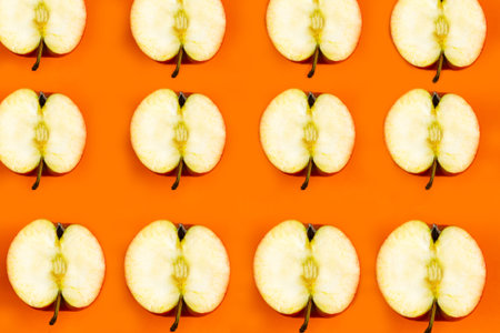 Sliced apple pattern on orange background, minimal concept