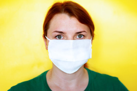 Portrait of young woman in medical mask, closeup, covid-19 concept