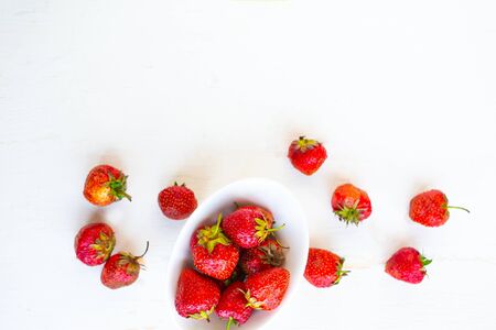 Fresh tasty strawberry on white plate, top viewの写真素材