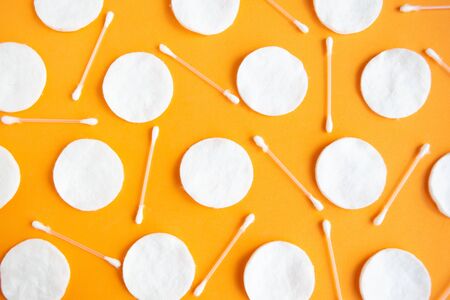 Cotton sponges and cotton buds pattern on orange background, minimal conceptの写真素材