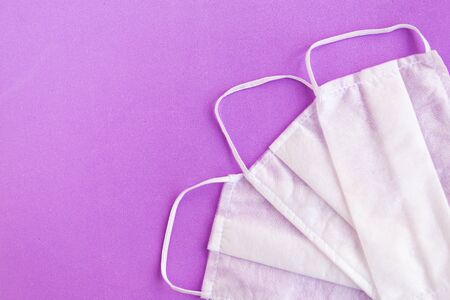 Medical masks on purple background, covid-19 concept, copy spaceの写真素材