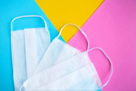 Medical masks on color geometric background, covid-19 concept, copy spaceの写真素材