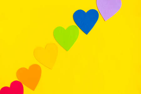 Hearts in lgbtq colors on bright yellow background, top viewの写真素材