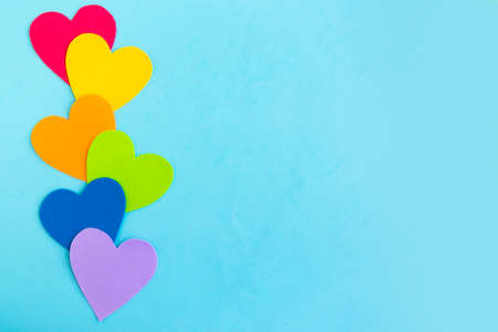 Hearts in lgbtq colors on blue background, top view, copy spaceの写真素材