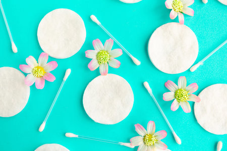Cotton sponges and cotton buds pattern on blue background, minimal concept