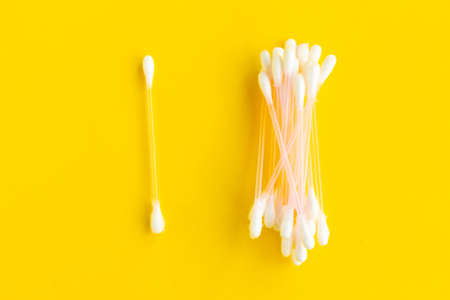 Cotton buds on bright yellow background, top viewの写真素材