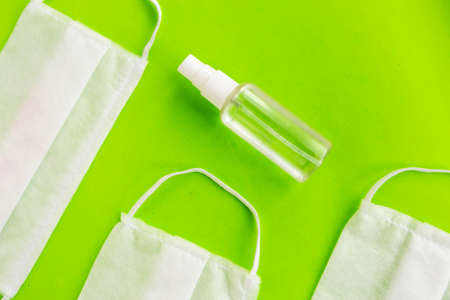 Medical masks and antiseptic on green background, minimal concept, coronavirus conceptの写真素材