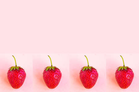 Strawberry pattern on pastel pink background, copy space for the textの写真素材