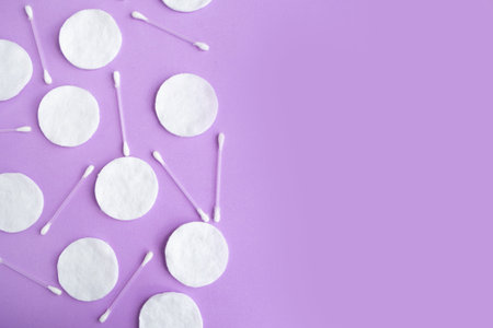 Cotton sponges and cotton buds pattern on purple background, minimal concept, copy space