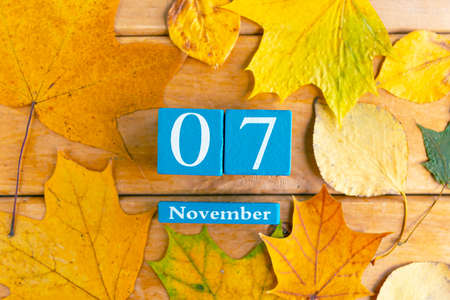 November 7th. Blue cube calendar with month and date on wooden background.の写真素材