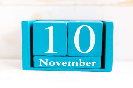 November 10. Blue cube calendar with month and date on wooden background.の写真素材