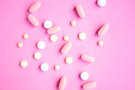 Medical pills on bright pink background, top viewの写真素材