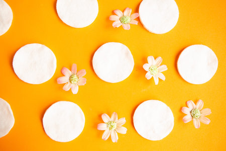 Cotton sponges pattern on bright orange background, minimal concept