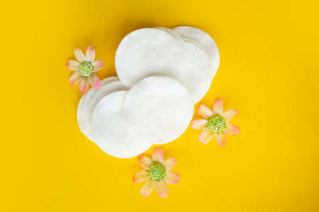 Cotton sponge on bright yellow background, top view, copy spaceの写真素材