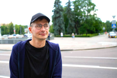 portrait of a young man on the background of cityscape, closeupの写真素材