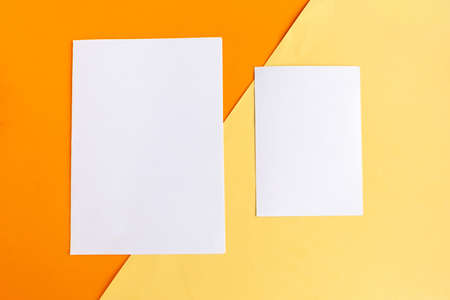 Two white mockup blanks on geometric orange and yellow background. Copy space for the text.の写真素材