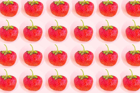 Strawberry pattern on pastel pink background, minimal conceptの写真素材