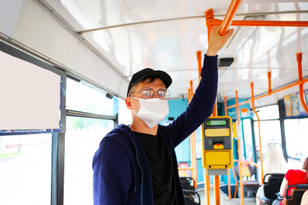 Man in protective medical mask in bus. Public transport during coronavirus covid-19 pandemic