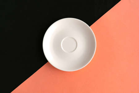 Empty plate on black and pink background. Copy space for the text. Minimal conceptの写真素材
