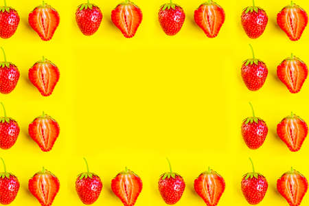 Strawberry frame pattern on bright yellow background, minimal conceptの写真素材