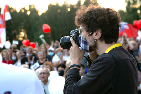 Minsk / Belarus - July 30, 2020: photographer in face mask works at the eventのeditorial素材