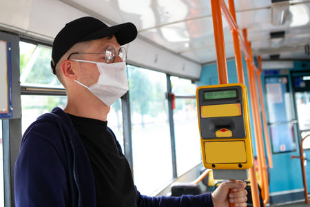 Man in protective medical mask in bus. Public transport during coronavirus covid-19 pandemic