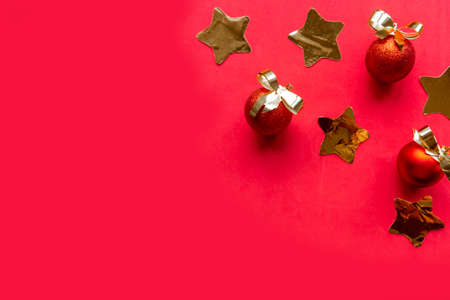 Golden Christmas decorations on red background, top view, copy spaceの写真素材