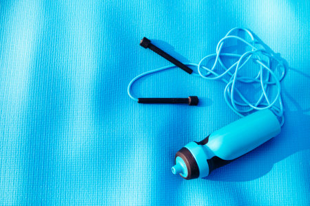 Jump rope, water bottle and a gym mat - equipping for outdoor activityの写真素材