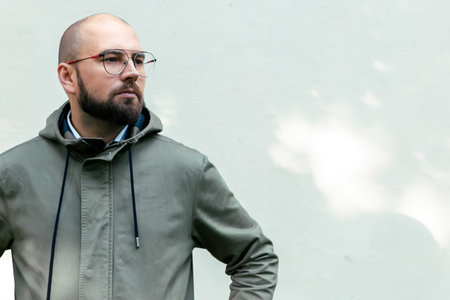 young guy with a beard and glasses, fashion man, outdoor portrait, close up