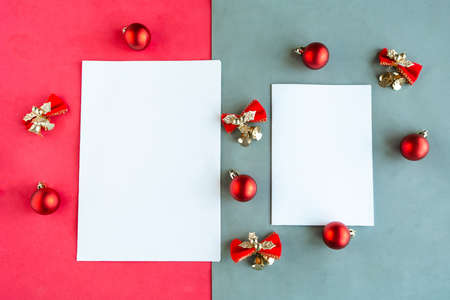 Two white mockup blanks and Christmas decorations on color background. Copy space for the text. Template for Christmas card. Merry Christmas and Happy new yearの写真素材
