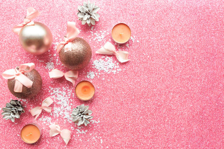 Christmas baubles with bows on pink glitter background. Merry Christmas greeting cardの写真素材