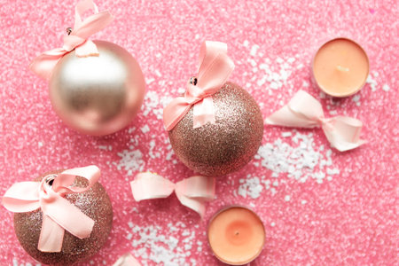 Christmas baubles with bows on pink glitter background. Merry Christmas greeting cardの写真素材